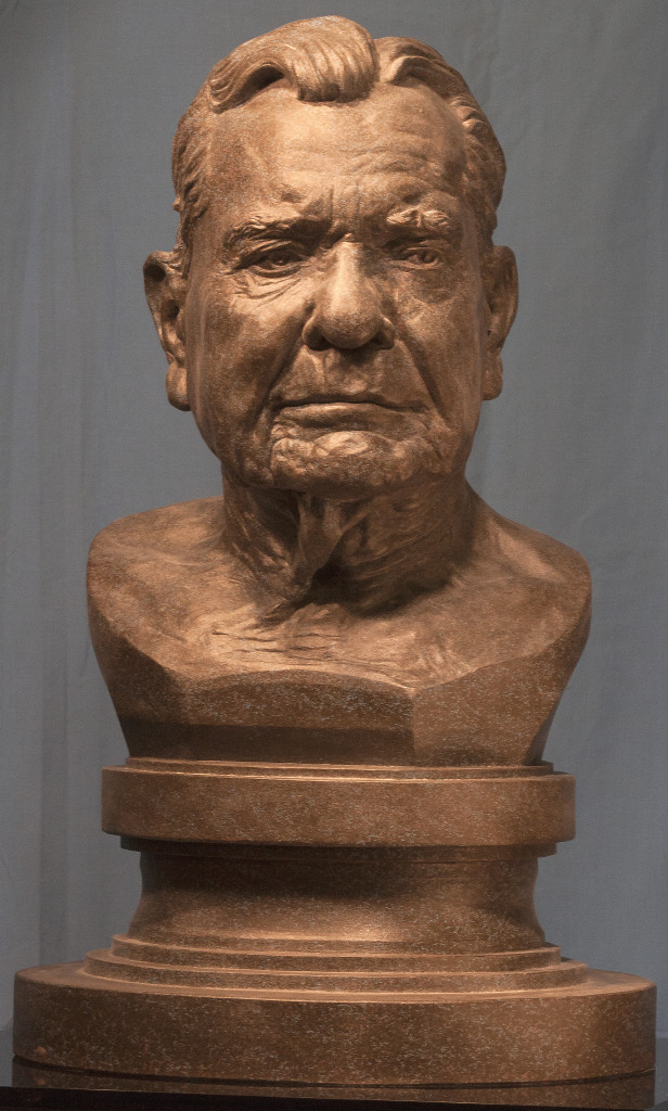 A. Gilmore Flues, sculpted from life by P. Brad Parker; plaster cast with patina from clay; subject of portrait served as Assistant Secretary of the Treasury in the Eisenhower Administration